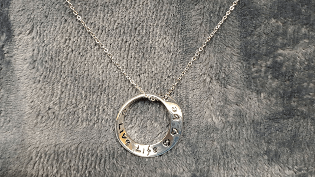 Silver Coloured Twisted Ring Necklace Inscribed.